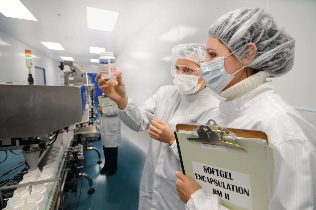 Two Scientist in lab hold up maplelife bottle